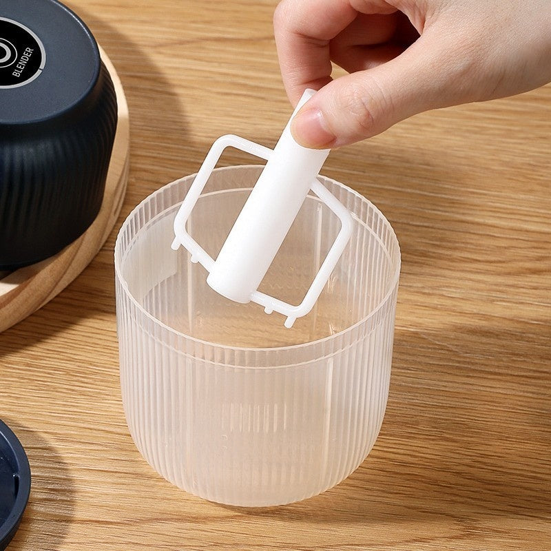 Hand using the Electric Garlic Chopper&